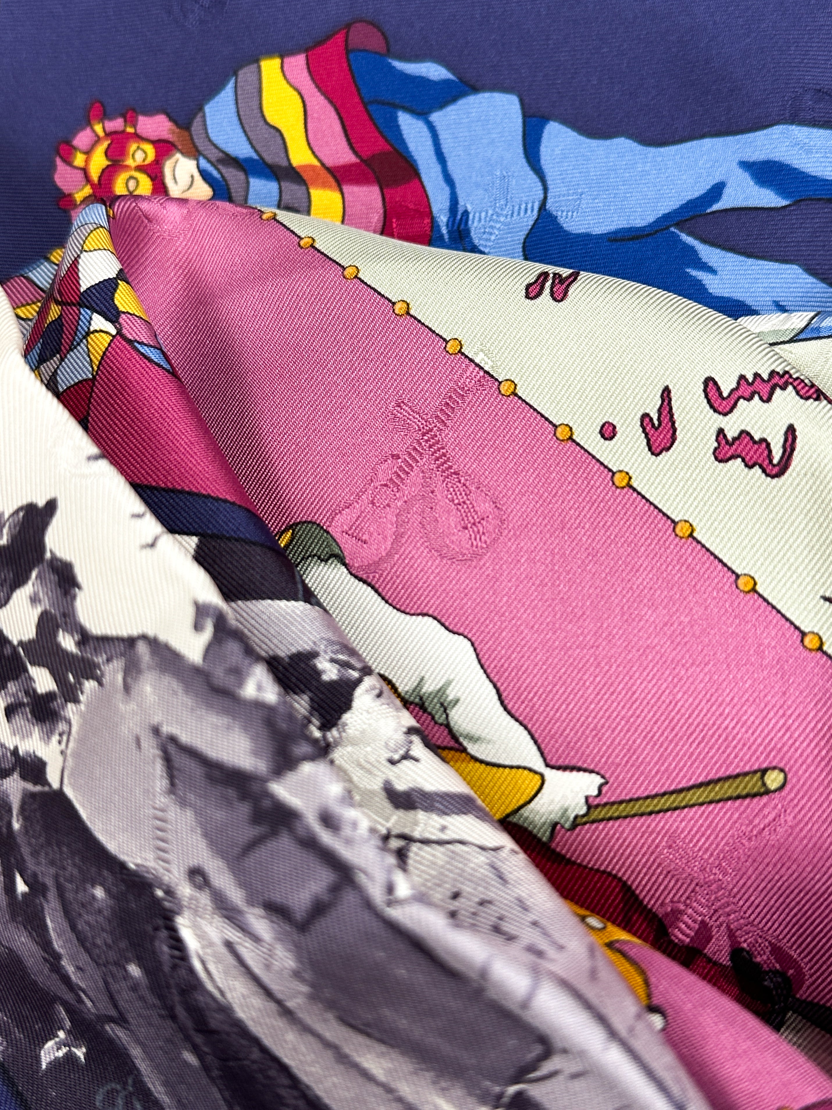 Collection of colorful scarves with a brand logo on a blue background